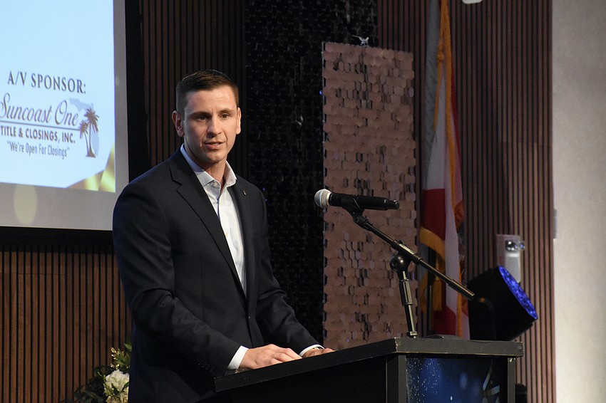 Mirza Velic, chief experience officer at Sarasota Ford, claims the Large Business of the Year award.