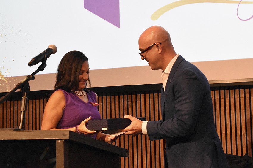 Michelle Olivo of Castle Concierge claims the Breakthrough Business of the Year award from Erik Vatter, president of Bank of America