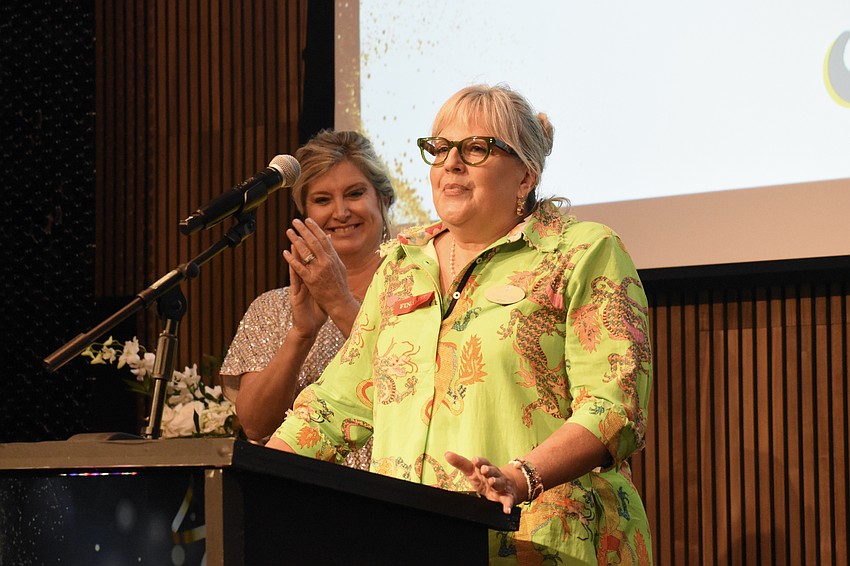 Heather Kasten applauds Tammy Hauser of Discover Sarasota Tours as she accepts the Woman-Owned Business of the Year award.