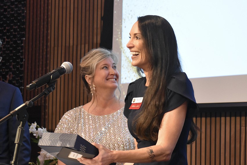 Heather Kasten welcomes Kendra Simpkins, founder of Operation Warrior Resolution, to claim the Non-profit of the Year award.