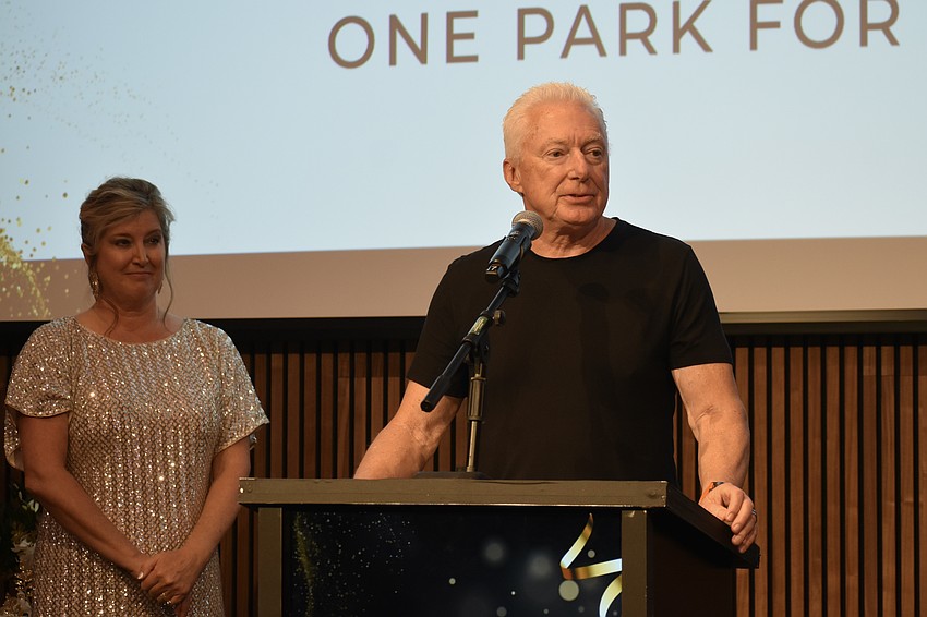Heather Kasten looks on as AG Lafley, CEO of The Bay Park Conservancy Inc., claims the Community Impact award.