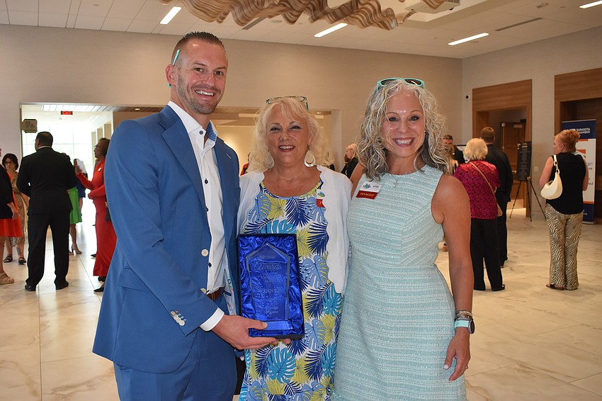 ActivAge CEO Kris Chana holds the Rising Star award, with Deb Overley and April McManara