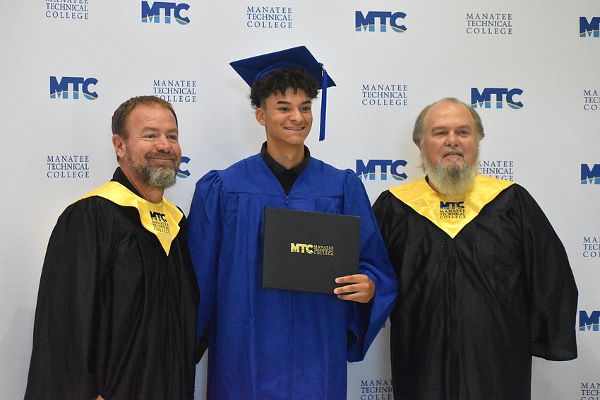 MTC instructor Shane Baxley, graduate Dylan Brown and instructor Steven Whalen celebrate Baxley's graduation from the automotive collision technology program.