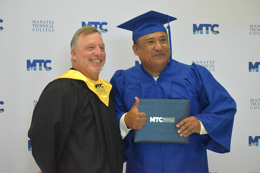 Baking and Pastry Arts Instructor Ed Catalane poses with graduate Denver Inopiquez.