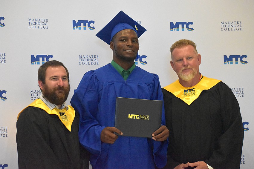 Instructor Ron Tomlin, graduate Stepvon Saunders and instructor Freddie Fowler celebrate Saunders graduation from the marine service technologies program. Saunders works at Poseidon Marine in Ruskin, Florida.