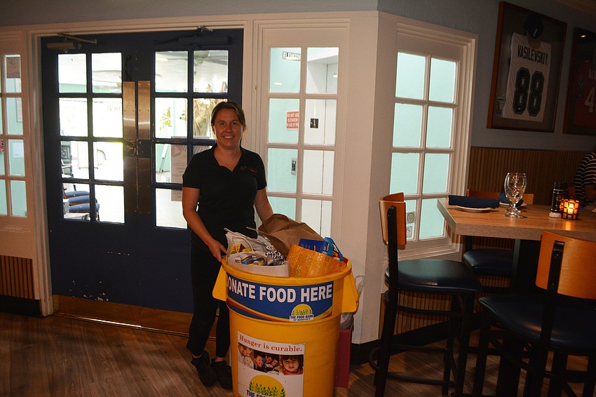 Manager Kate Ruh standing with the second filled up bin for the annual 