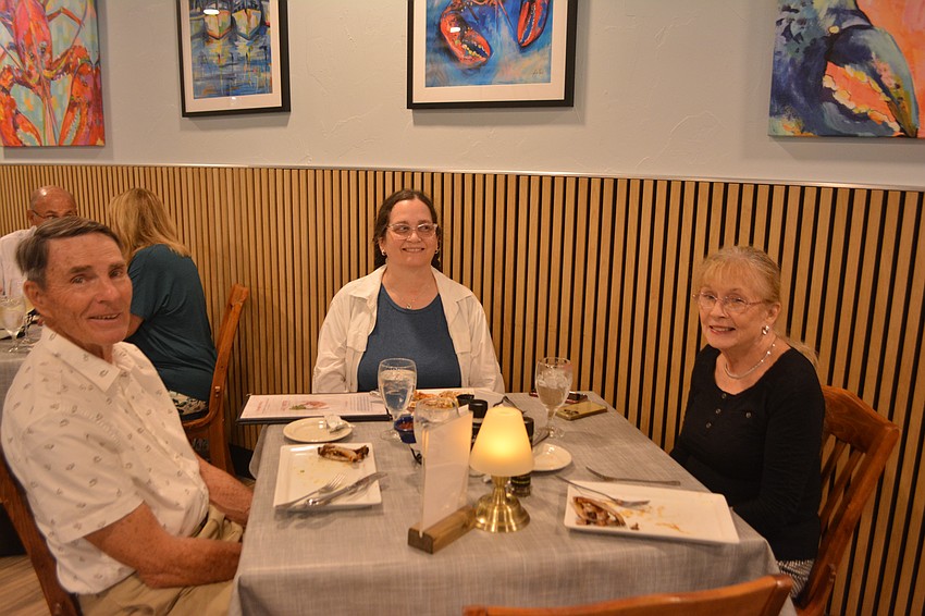 Jim Larson, Lora Ramsey and Lynn Larson all enjoy the festive feast for the annual 