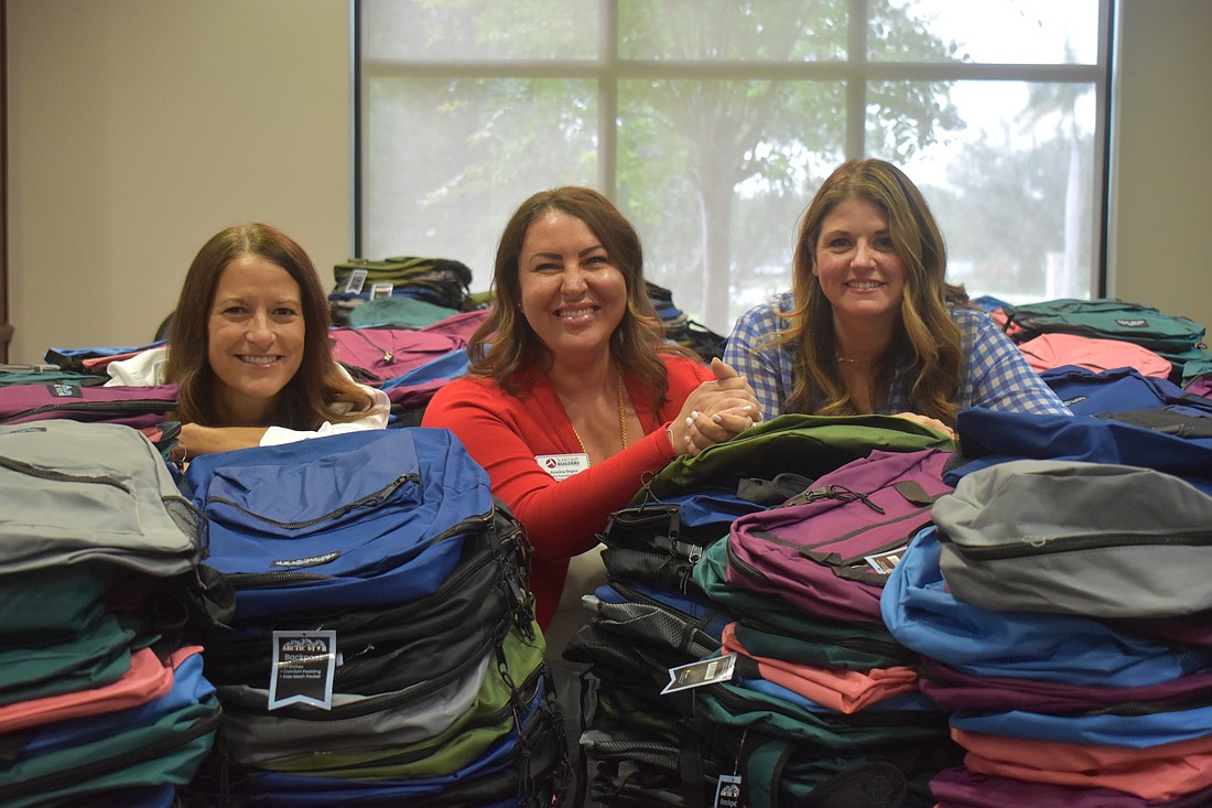 Tracy Eisnaugle, professional women in building chair, Jessica Seper deputy executive officer and membership and councils director and Megan Schroeder, young professional committee co-chair were behind the Stuff the Backpack event.