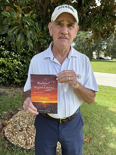 Ed Llewellyn holds his memoir, "The Sound of the Whippoorwill." Courtesy photo