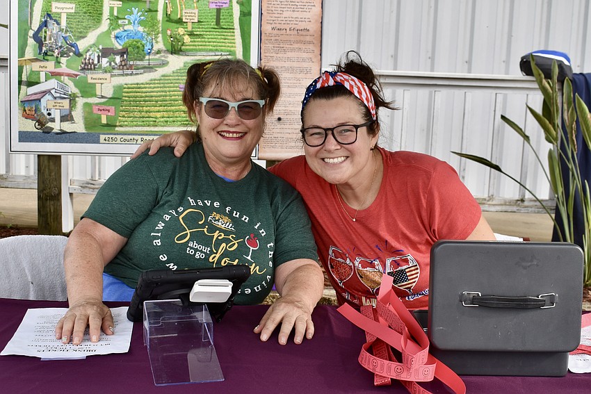 Lisa Gaines and Stephanie Farquhar check in guests at the fifth annual Red, White and Blueberry Celebration at Fiorelli Winery.