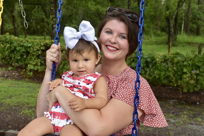 Sarasota's Ivana Zavala More swings with her 17-month-old daughter Isabella during the event.