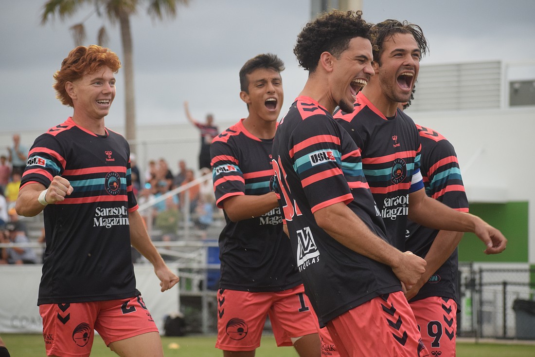 Sarasota Paradise players Owen Barnett, Felipe Rojas, Jeffrey White and Andres Freire celebrate a goal by White against Weston FC on June 28 at Premier Sports Campus.