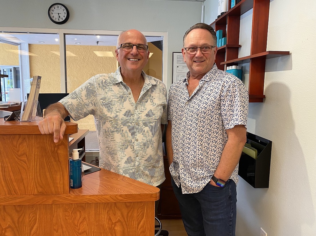 Greg Koss and David Roy, owners of David Gregory Salon, share an afternoon with friends at the shop before closing its doors.