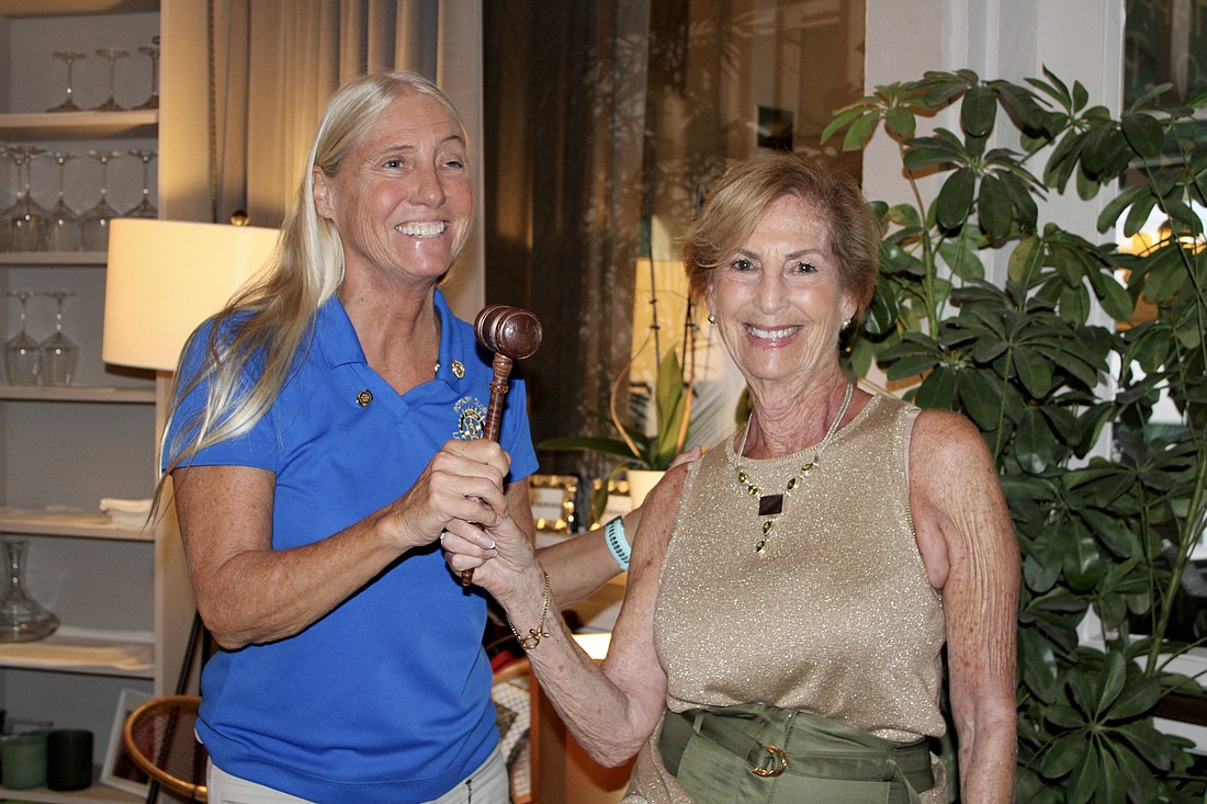 Outgoing Rotary Club of Longboat Key President Jan Wallace and incoming President Terri Driver crack a smile after Wallace officially passes the gavel on June 24 at Hugo's II.