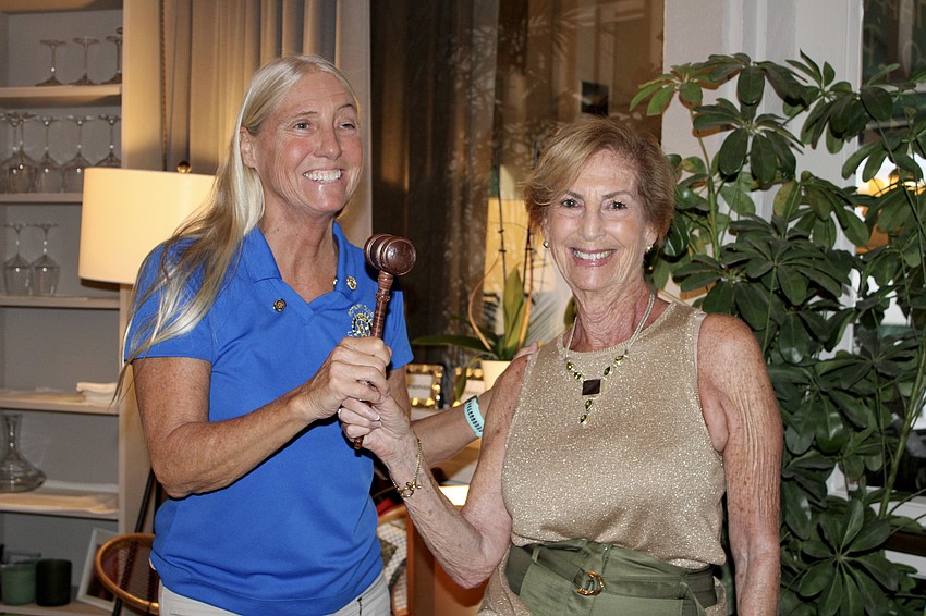 Outgoing Rotary Club of Longboat Key President Jan Wallace and incoming President Terri Driver crack a smile after Wallace officially passes the gavel on June 24 at Hugo's II.