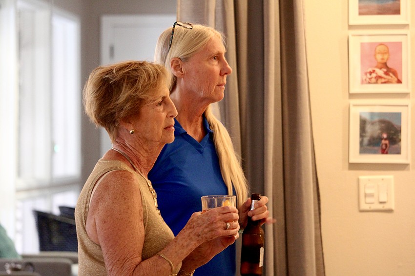 Jan Wallace and Terri Driver contemplate Jeff Driver's comments on the change in leadership at Rotary Club of Longboat Key.