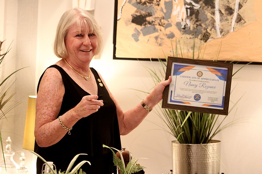 Rotary Club of Longboat Key member Carol Erker shares a special recognition given to Nancy Rozance for her work in water safety education.