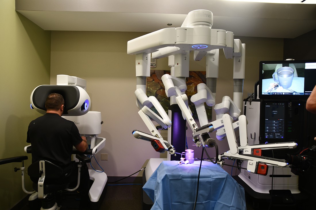 Luke Elms, general surgeon at Dr. P. Phillips Hospital demonstrated how the robotic arm works on Monday, June 23.