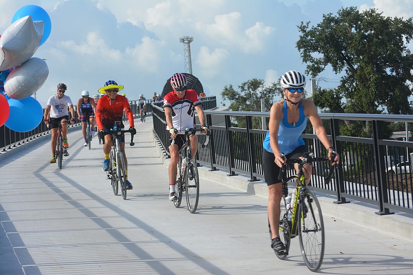 Biker of the Friends of Legacy Trails are all smiles for the Legacy Trail bridge.