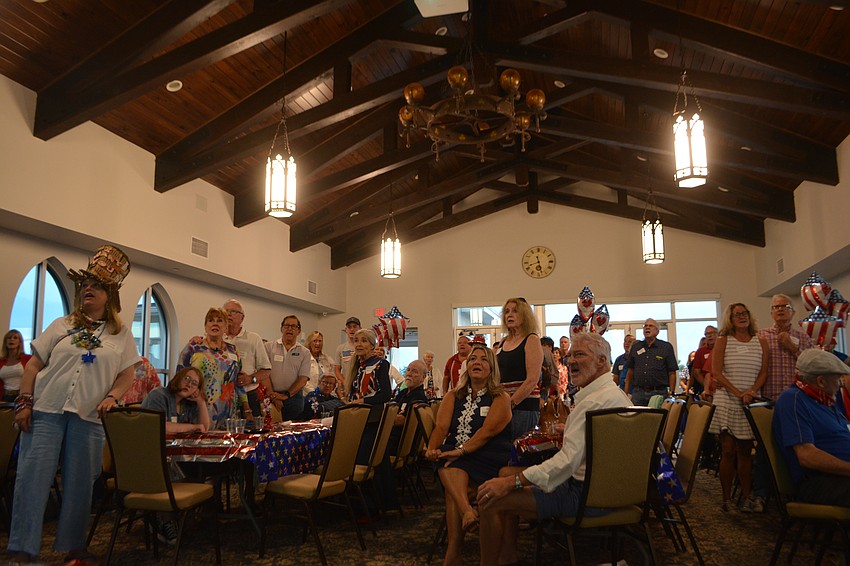 Members of Church of the Redeemer all stand together to sing American Classics led by Choralmaster, Sam Nelson.