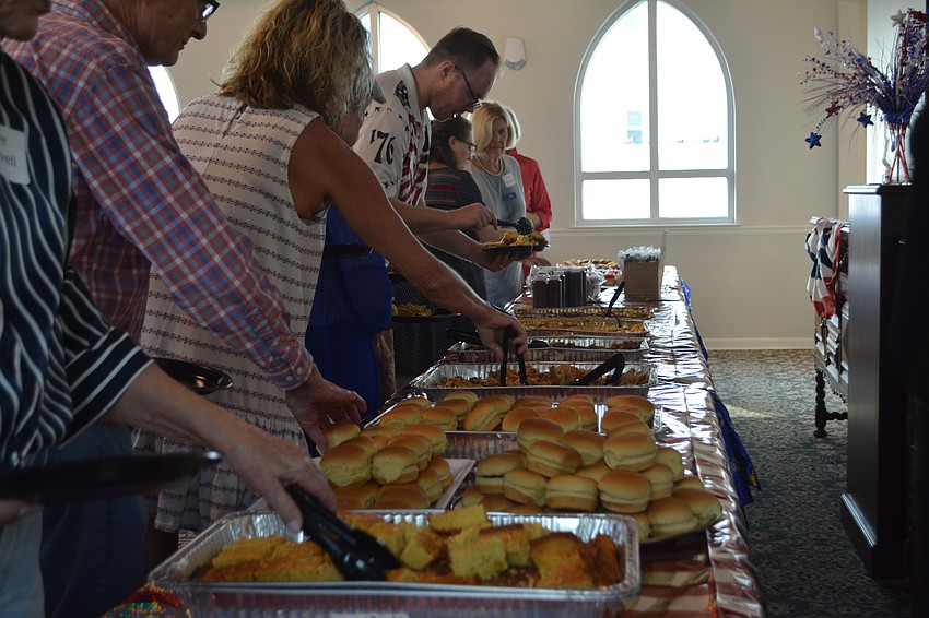 Everyone is lined up for food catered by Mission Barbeque.
