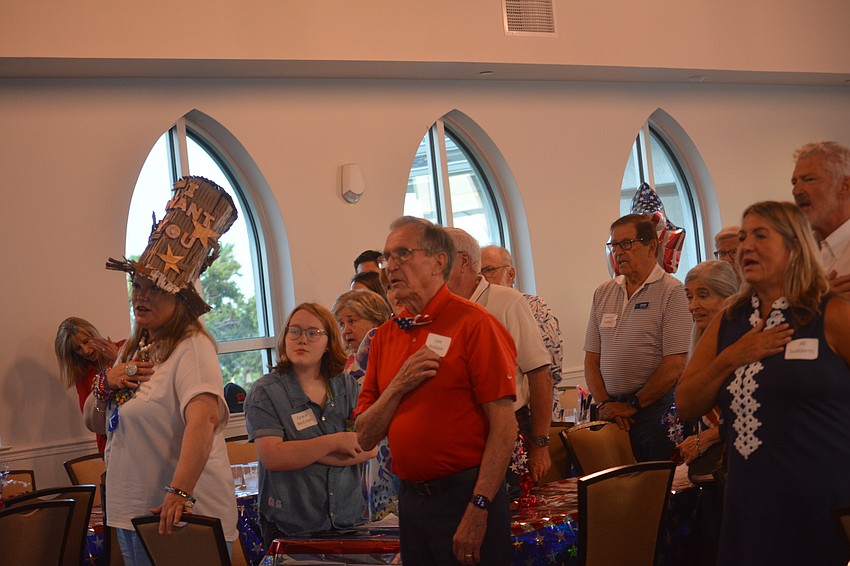 Members all join together to sing the National Anthem.