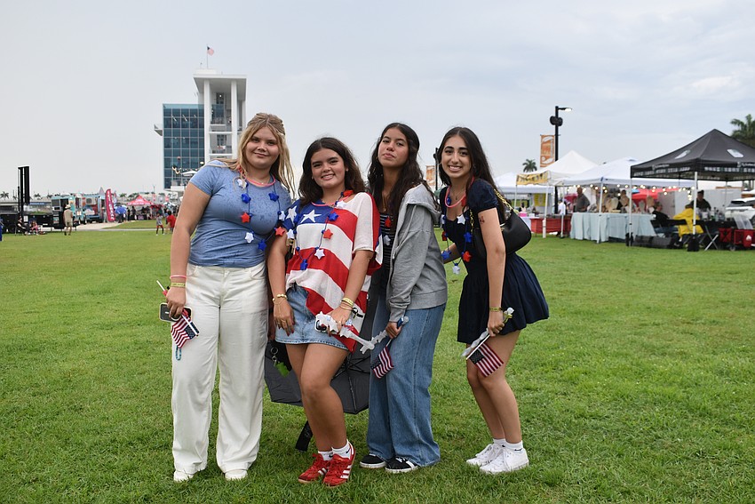 Sarasota's Finley Raber, Grace Carr, Aranza Gomez and Giovanna Pisano hang out by the stage for the live music at Fireworks on the Lake.