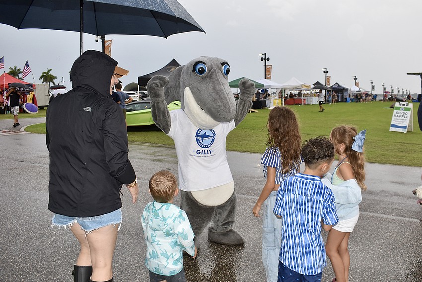 Gilly the Shark, who obviously felt right at home in the rain, dances his way around Nathan Benderson Park July 3 during the Fireworks on the Lake event.
