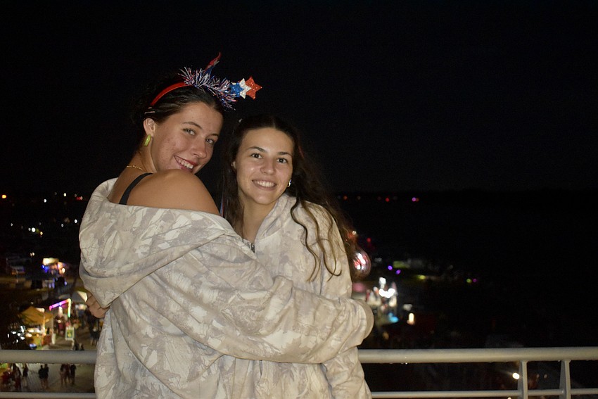 North Port's Olivia Geler and Sarasota's McKenna Bonura wait for the fireworks to begin July 3 at Nathan Benderson Park.