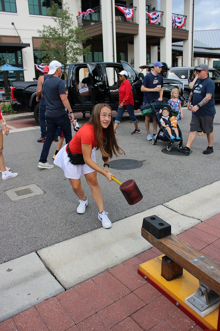 Lakewood Ranch's Milana Nanna, 14, takes a shot at ringing the bell in the one of the carnival games at Star-Spangled Spectacular July 4 at Waterside Place.