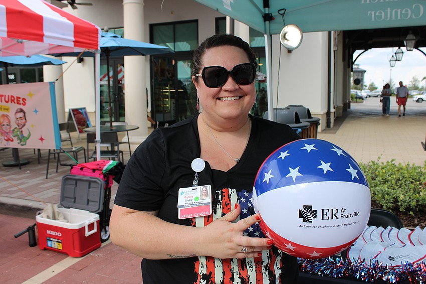 Gabbie Taylor, the nursing manager at Lakewood Ranch Medical Center's ER at Fruitville, was handing out beach balls at Star-Spangled Spectacular.