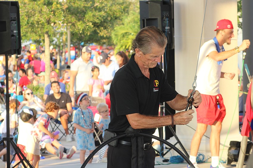 Pedro Reis, the founder of the Circus Arts Conservatory, which was featured at Star-Spangled Spectacular at Waterside Place, checks the equipment before the show.