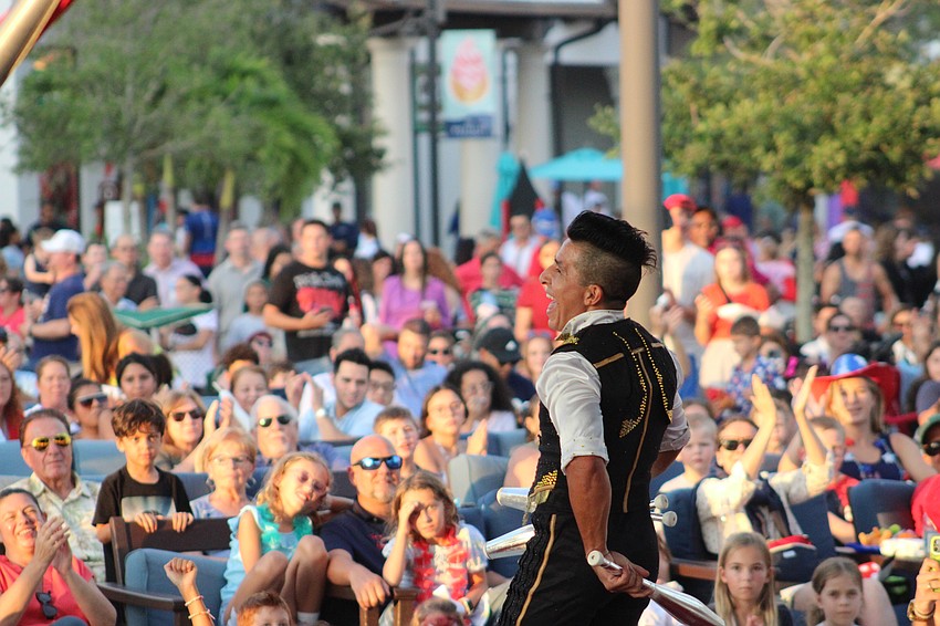 Speed juggler Nilson Escobar obviously enjoys his work in front of the crowd at the Waterside Place Pavilion.