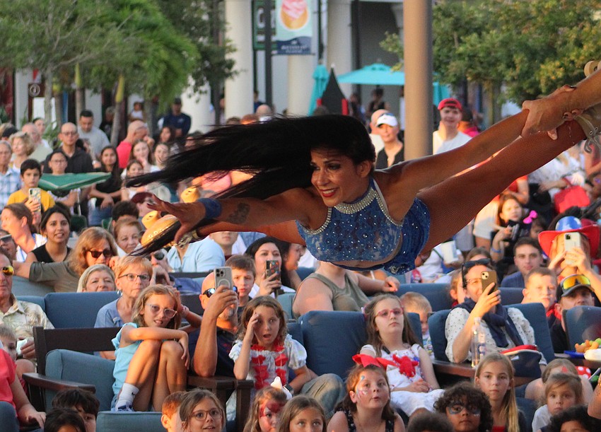 Roller skating sensation Anita Zeman manages to keep smiling, even as her husband Karoly Zeman launches her into the air under the Waterside Place Pavilion July 4 during Star-Spangled Spectacular.