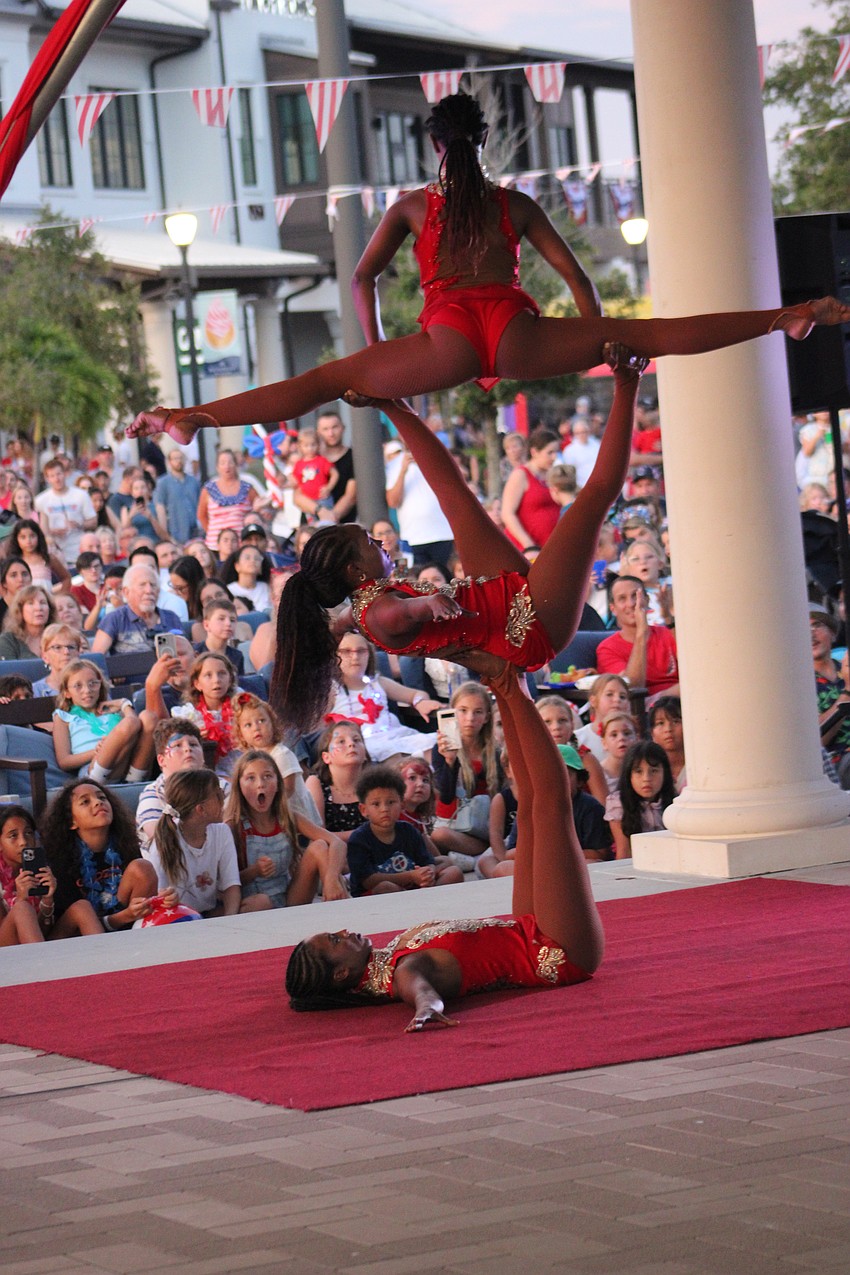 The Trio Black Diamond hand balancing act thrills the crowd at Waterside Place during the Star-Spangled Spectacular July 4.
