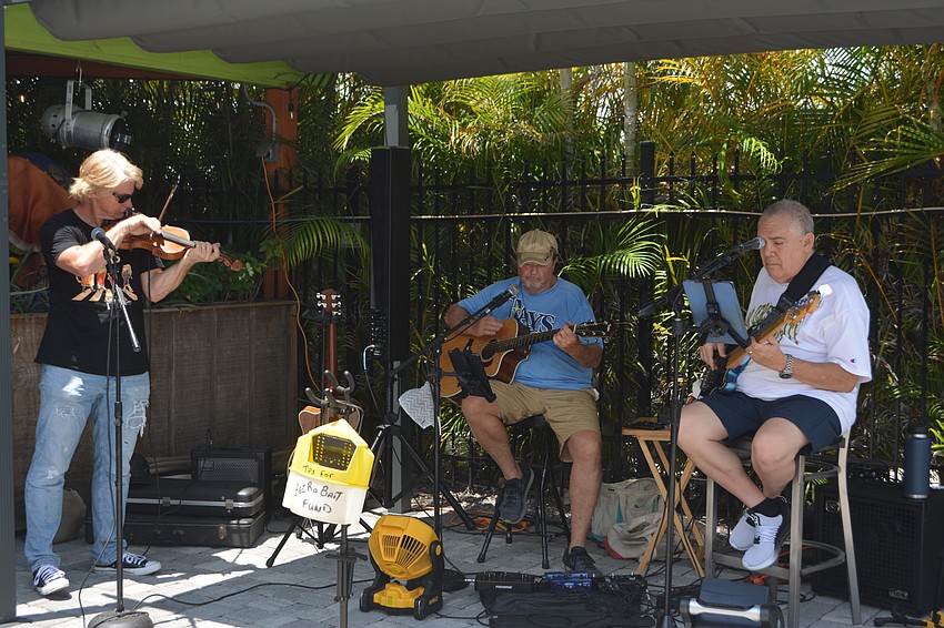 Violinist John Reynolds, Capt. John Negele and basists Mike Pepe provide the tunes for the fifth annual Hot Dog Day.