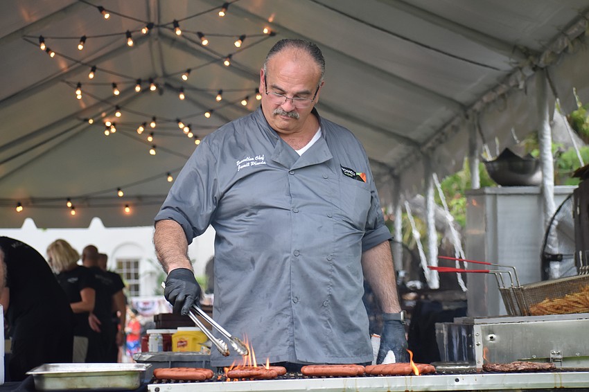 Jamil Pineda, executive chef at Michael's on East, grills hot dogs.