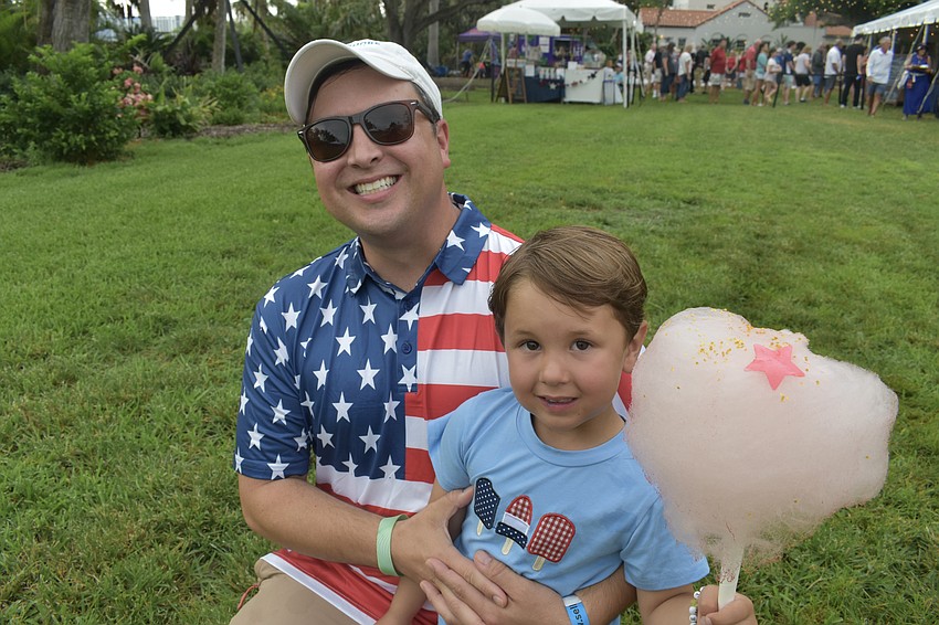 Daniel Munn and his son Camden Munn, 4, enjoy cotton candy.