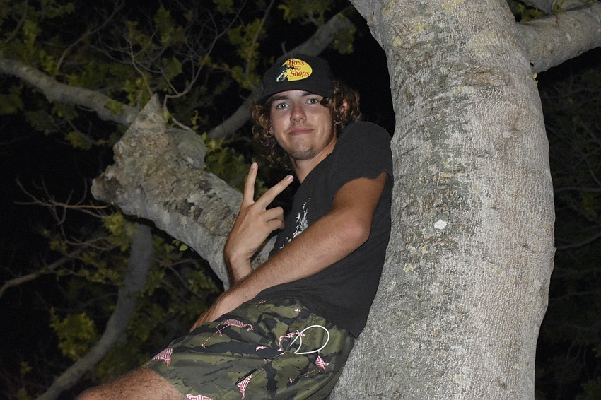 Logan DeWitt, 16, watched the fireworks from the trees.