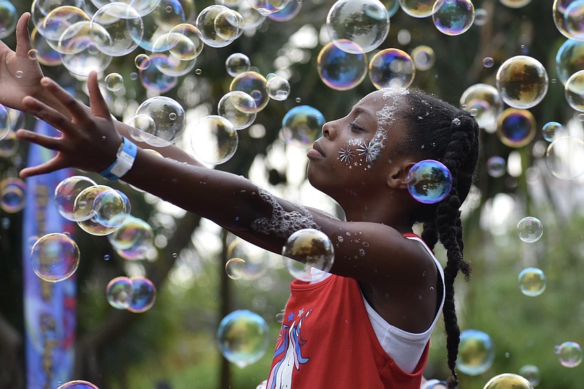 Amirah Graham, 11, enjoys the bubble show.
