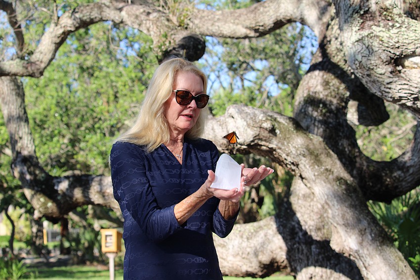 Susan Phillips, this year's Freedom Fest grand marshal, releases a monarch butterfly at the Longboat Key Garden Club's butterfly release at Bicentennial Park.