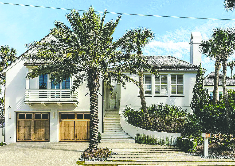 Oceanfront home features six bedrooms, five full and one half-bathrooms, courtyard pool, elevator, guest suite, wine cellar, gym, balconies, porches, outdoor kitchen, two-story detached garage apartment and dune walkover.