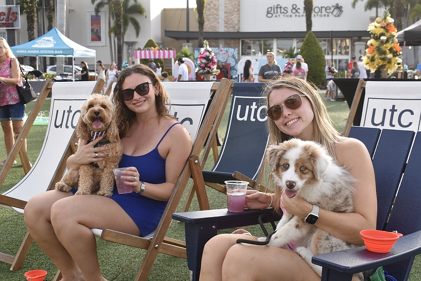 Bradenton's Alison Daymon and Morgan Walters get into the spirit of Barks and Brews with a cocktail in one hand and a dog in the other.