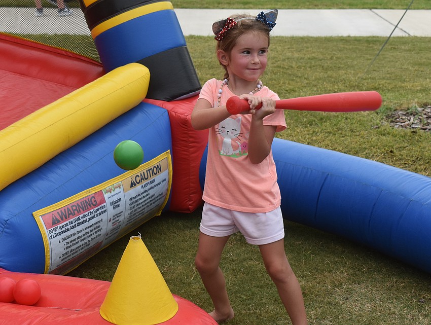 Lakewood Ranch resident Ryelee Romero, 4, takes her turn at one of the games at Movie in the Park July 11