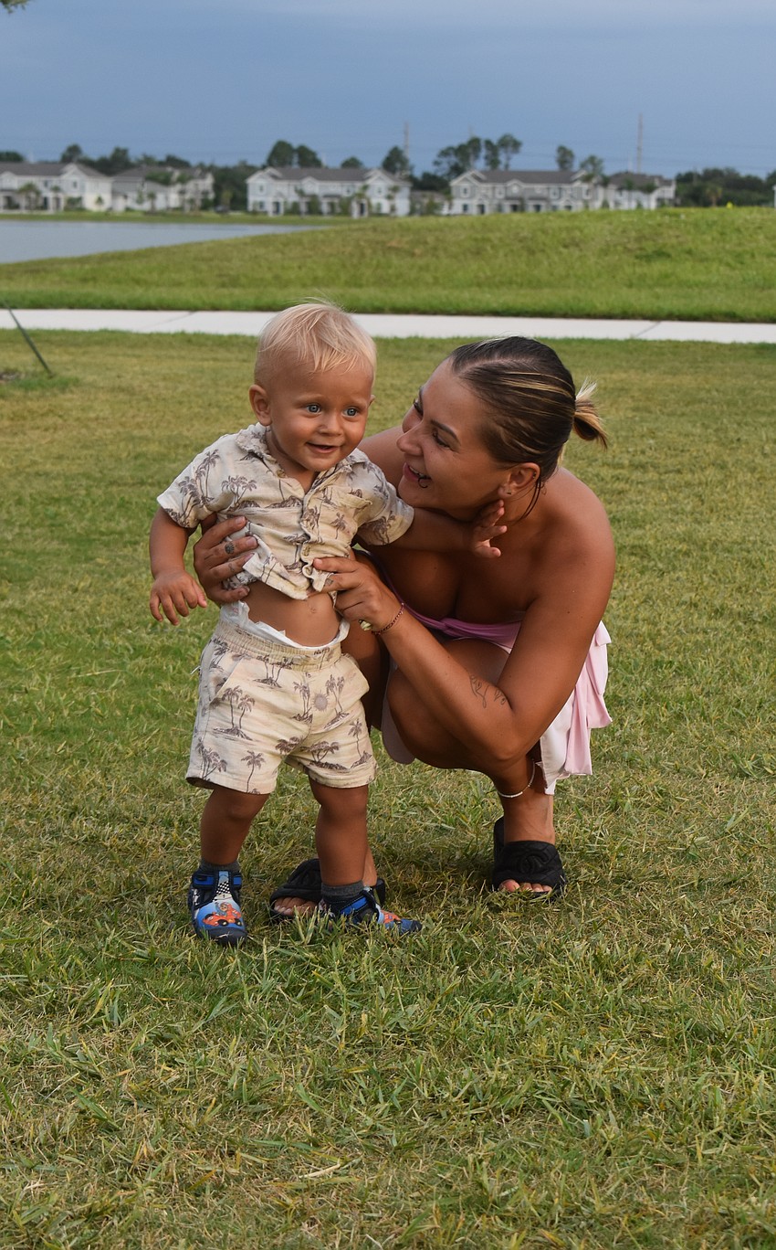 Lakewood Ranch resident Sylwia Pikul plays with her 1-year-old Tosiek Pikul-Wawrzyk before the start of 