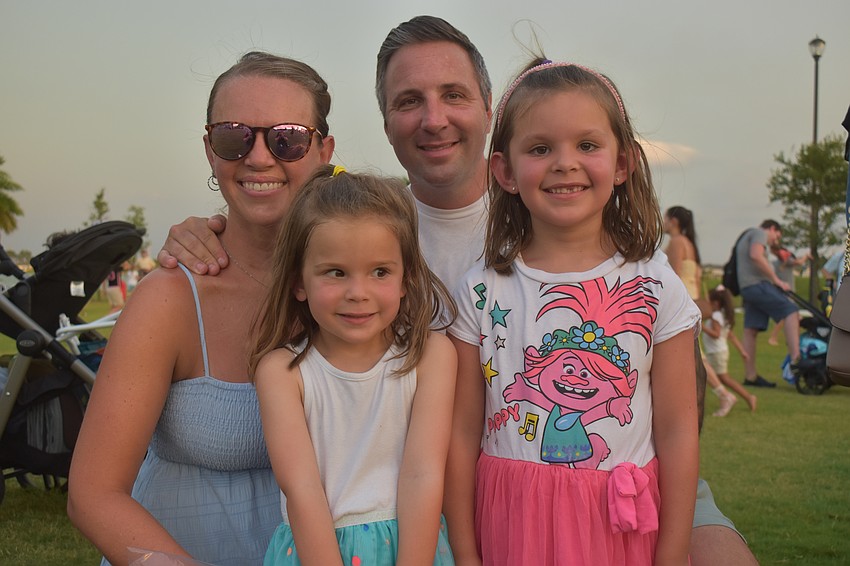 Parrish residents Jen and Adam Schneider bring their daughters Kinsley and Kira to watch 