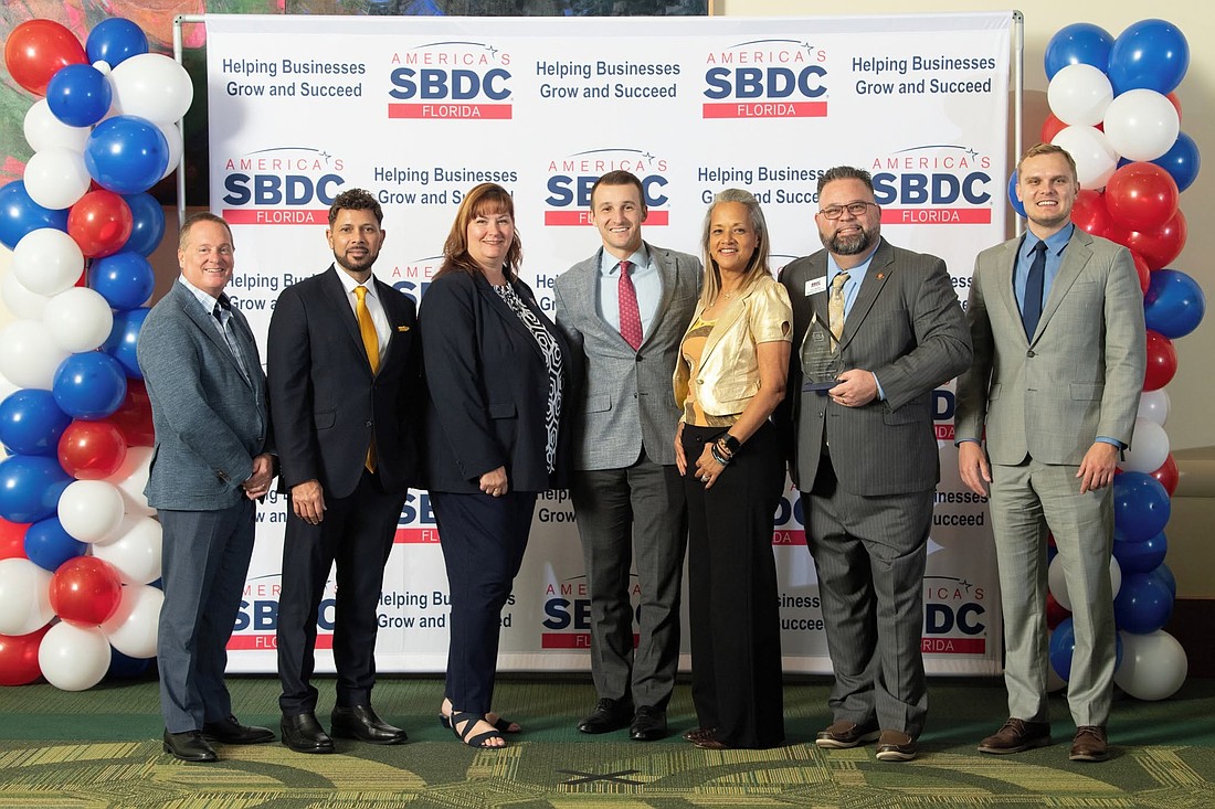 SBA Southeast Regional Administrator Tyler Teresa, center, attends the Small Business Development Center awards ceremony at USF in Tampa.