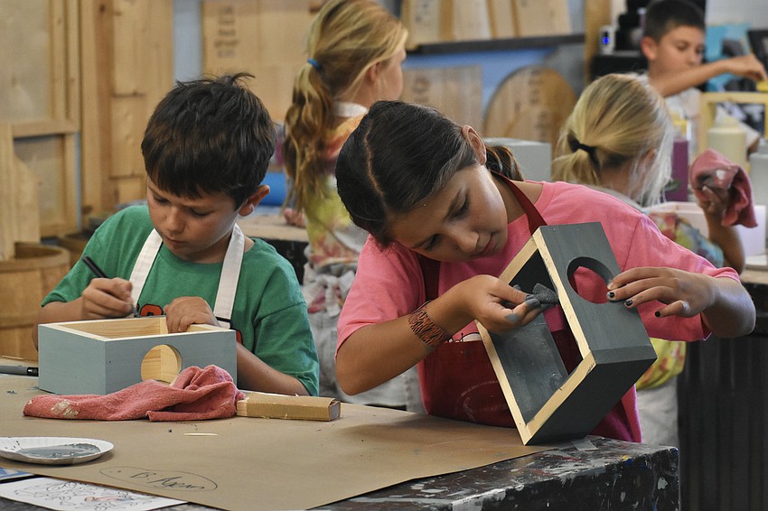 Brendon Letarte, 8, and his siter Emily Letarte, 11, work on their projects.