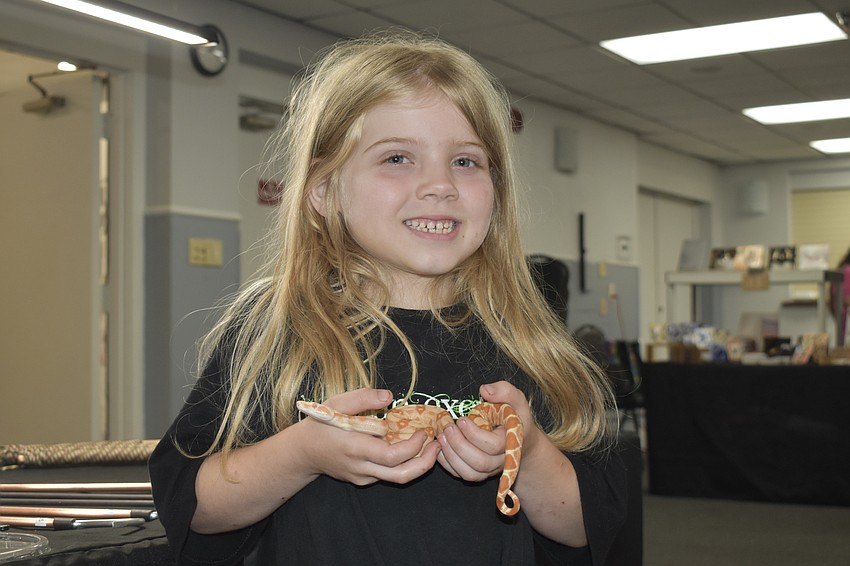 Phoebe Sked, 6, of Brooksville, holds a Sharp Sunglow.