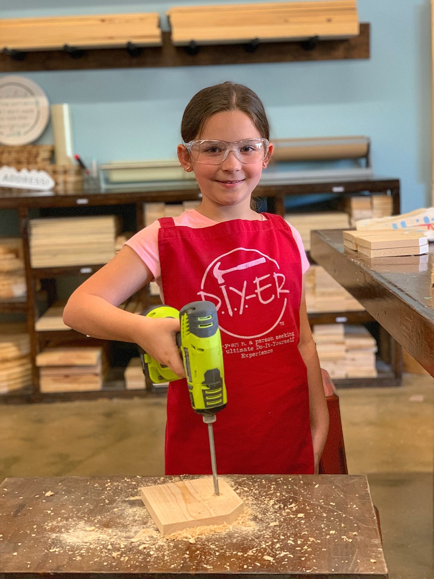 Paola Livon, 11, uses a drill during this year's summer camp.